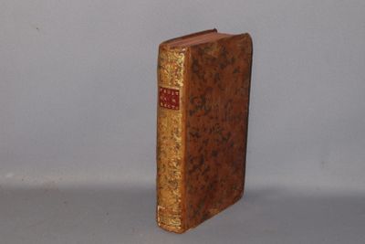 an old book that is sitting on a table
