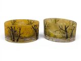 pair of yellow and black candles with trees on them on a white background