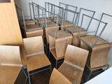 a lot of chairs that are lined up in a room