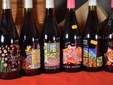 six bottles of wine are lined up in a row on a table