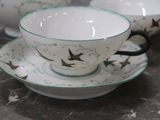 three cups and saucers sitting on a table
