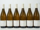 six bottles of wine are lined up in a row on a table