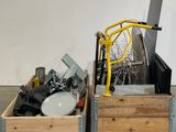 a wooden crate with a laptop and a pile of other items