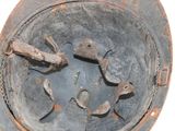 an old rusty metal object with a hole in it