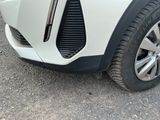 a close up of a car ' s front bumper and tire