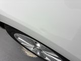 a close up of a tire on a white car
