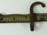a close up of a knife on a white surface