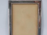 a silver picture frame with beading around the edges