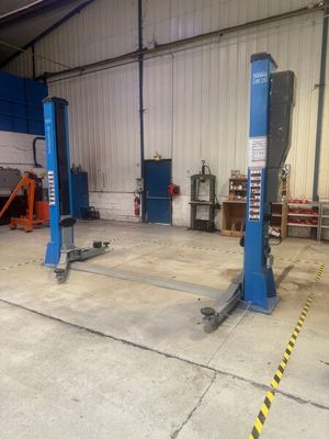 two blue lifts in the garage of a building