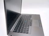 a silver laptop with a black keyboard on a white surface