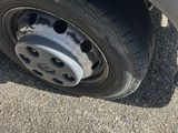 the tire of a car with a flat tire on the pavement