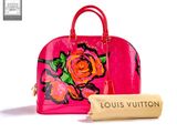 louis vuitton handbag with a roll of toilet paper next to it