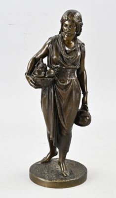 bronze statue of a woman holding a basket of flowers on a base