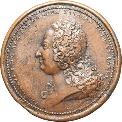 gros plan d'une pièce de monnaie sur laquelle figure une tête de femme
