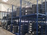 a lot of tires stacked on a rack in a warehouse