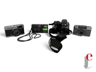 three cameras and a camera strap on a white background