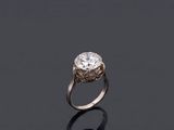 an engagement ring with a round brilliant cut diamond set in 18k white gold