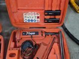 two orange tools in a case on the floor