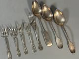 a lot of silver spoons and spoon spoons on the table