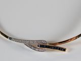 a close up of a necklace on a white surface