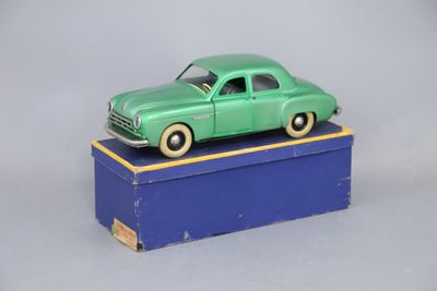 a green toy car sitting on top of a blue box