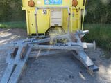 a yellow trailer that is parked on the side of the road