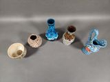 five small vases that are sitting on a table