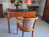 a desk with a chair and a lamp in a room