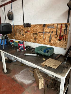 a workbench with tools on it in a garage