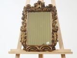 a wooden easel with a mirror on top of it