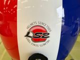 a close up of a motorcycle with a red, white and blue helmet