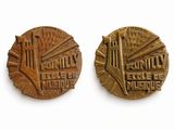 two bronze medals depicting a city and a bridge
