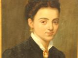 portrait of a woman in a black dress with a yellow tie