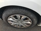a close up of a tire on a white car