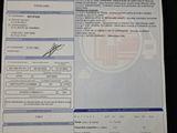 an autograph of a driver ' s license is shown on a table