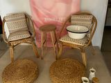 two wicker chairs and a table with a bowl on it