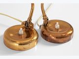 pair of brass table lamps with brass bases and a white background
