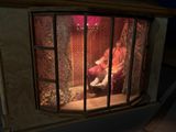 a man sitting in a chair inside of a small window