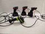 three different types of handheld video game controllers on a table