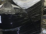 a large pile of black plastic wrapped up in a warehouse