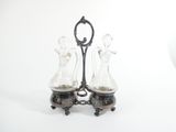two glass vases sitting on top of a metal stand