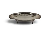 a silver plate on a stand on a white background