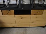 a wooden cabinet with a black top and a black base