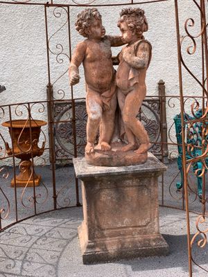 a statue of a boy and a girl kissing in a gazebo