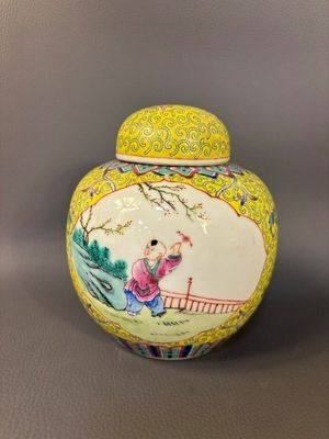 yellow and white vase with a woman sitting on a bridge