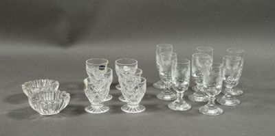 a group of glasses and vases sitting on a table