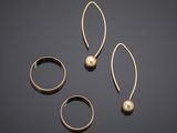 a set of three gold rings and a pair of earrings