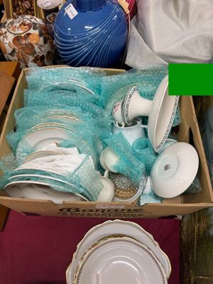 a box full of plates and bowls sitting on a table
