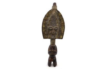 a close up of a wooden sculpture of a person holding a shield