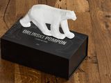 a figurine of a white bear on a black box